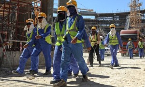 Foreign laborers work in Doha